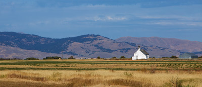 field with mountains and blue sky