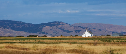 image of field and small white building