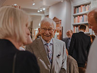 old couple visiting in a group